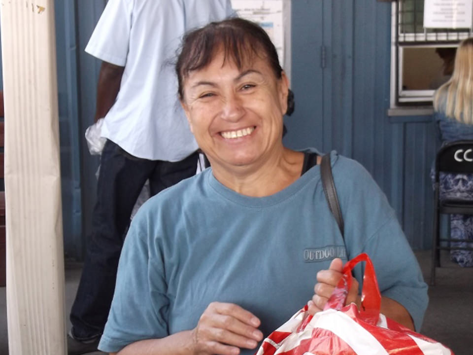 Woman smiling holding bag